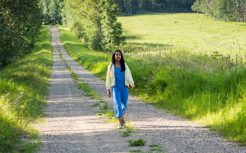 a girl goes on a walk outside her home, a productive activity